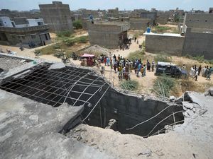 A big hole is seen on the roof of a house suspected to have been damaged in an Indian drone attack in Karachi, Pakistan