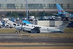 Plane drags along the runway at Birmingham Airport after making an emergency landing.
