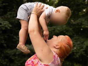 Rhiannon Whyte holds a child in the air