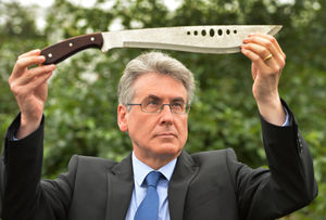 West Midlands Police and Crime Commissioner Simon Foster with weapons from the region's surrender bins