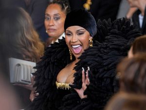 Supporting image for story: Cardi B dons dramatic feather-like bolero at Paris Fashion Week