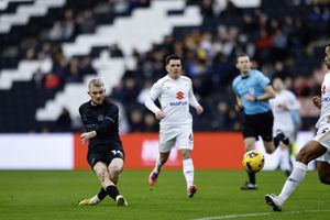 Taylor Perry of Shrewsbury Town shoots at goal during the game between MK Dons and Shrewsbury Town