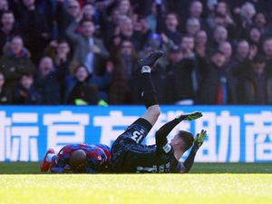 Millwall goalkeeper Liam Roberts clashes with Crystal Palace's Jean-Philippe Mateta