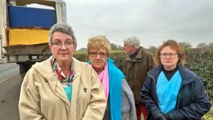 Iana Jacobson (left) with angry residents by one of the abandoned trailers on the A53. 
