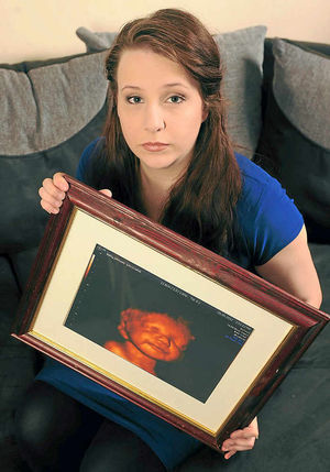 Katyia and a treasured picture of baby Lucian, who lived for a matter of hours