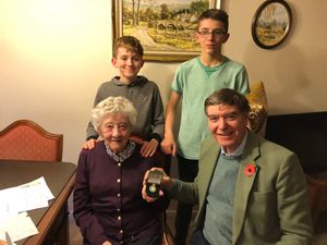 June Lee is presented with her Women's Land Army Badge