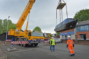 The boat being lifted into place on Newport's canal