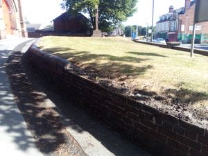 The church wall  at St Peter's with the missing stones
