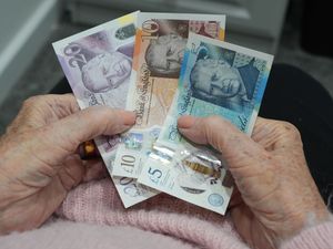 Someone holding a range of bank notes
