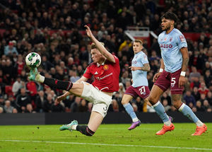 Manchester United's Scott McTominay scores his side's fourth goal during the English League Cup third round soccer match between Manchester United and Aston Villa in Manchester, England, Thursday, Nov. 10, 2022. (AP Photo/Dave Thompson).