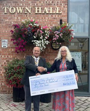 Mayor of Market Drayton Tim Manton (left) presents a cheque to CEO of Citizens Advice Shropshire, Jackie Jeffrey. Pic: Market Drayton Town Council