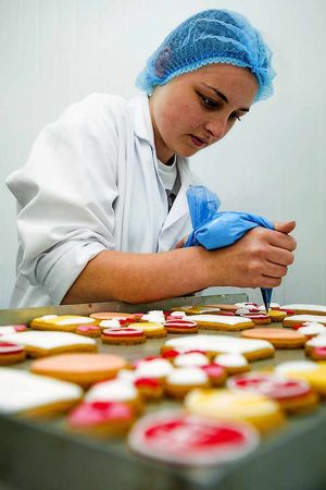 Production operative Charlotte Shropshire makes 'get well soon' cookies