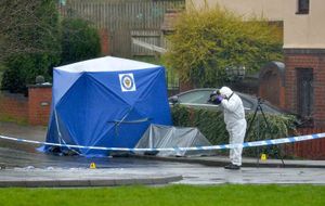 A police tent on Wilson Road, just off Pensnett Road, where two men were stabbed to death