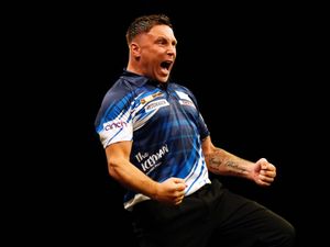 Gerwyn Price celebrates hitting a nine dart finish in the Premier League