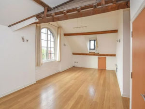 The property features exposed beam ceilings, giving the apartment a quaint setting