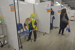 The vaccination booth gets cleaned down after Sophie Mills gets her vaccination
