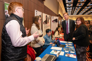Minister Timms and Principal and Chief Executive of QAC, Bev Jessop speak to one of the exhibitors
