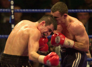 Joe Calzaghe, left, takes a punch from challenger Richie Woodhall.