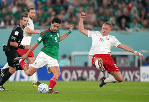 Mexico's Raul Jimenez and Poland's Kamil Glik battle for the ball during the FIFA World Cup Group C match at Stadium 974, Rass Abou Aboud. Picture date: Tuesday November 22, 2022.