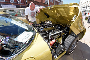 Gary Cole looks at the pristine engine of his 1972 E Type v12 Jaguar