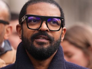 Noel Clarke wearing thick black rimmed glasses outside the Royal Courts of Justice