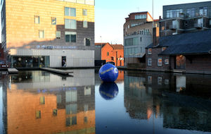 A giant inflatable Canal and River Trust buoy with the wording 'deep water' on it has been placed on the water in Walsall, near the art gallery.