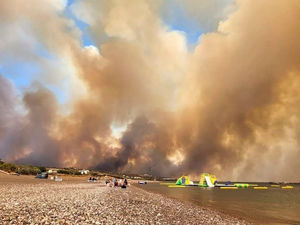 A large blaze burning on the Greek island of Rhodes for the fifth day has forced authorities to order an evacuation of four locations, including two seaside resorts. Photo: Rhodes.Rodos via AP.