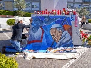 A painting of Pope Francis is placed outside a hospital in Rome