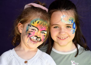 Dana McIvor, aged four and sister Anabelle, aged nine, all smiles with painted faces.