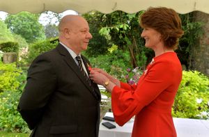 Shropshire's Lord Lieutenant Anna Turner presents the MBE to Glen Perkins.