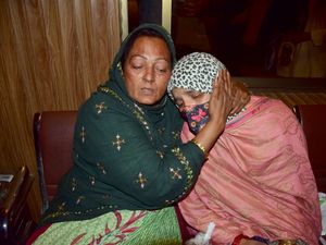 Passengers rescued by security forces from a passenger train attacked by insurgents comfort each other