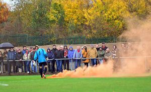 A flare is thrown from the crowd.