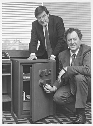 Chubb and Sons Lock and Safe Company Ltd., Wednesfield Road, Wolverhampton. Launch of a super secure plastic safe, designed to tolerate attacks by acid, power tools and torches, which had won a 1990 British Design Award. The photograph shows John Skelton (back) and Rodney Bunyan with the new safe. January 19, 1990.