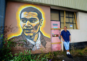 Steve Edwards beside his portrait of Goldie.