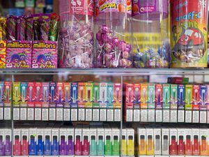 Disposable vapes of varying flavours and colours on sale in a store