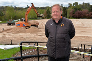 Wayne Lumbard watches as pitches are laid at the training base
