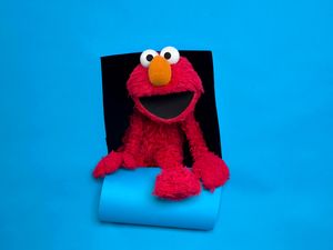Sesame Street's Elmo against a bluebackground