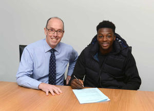 Dominic Iorfa of Wolverhampton Wanderers puts pen to paper on a new contract with Richard Skirrow club secretary