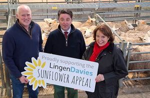Farmer Stuart Ashley (left) and Angela Hill from Lingen Davies Cancer Support with Halls director James Evans at Shrewsbury Auction Centre 