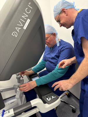 Reporter David Tooley, seated, using a robot simulator guided by top surgeon Mr Adam Farquharson. Picture: SaTH