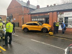 Supporting image for story: Shocked traders left to inspect the damage after car slams into shops