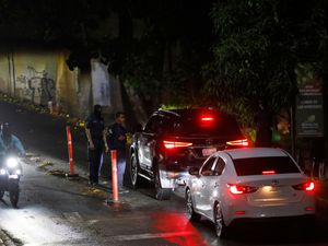 Police man a roadblock on a street leading to Argentina’s embassy in Caracas after members of Venezuela’s political opposition left the diplomatic mission