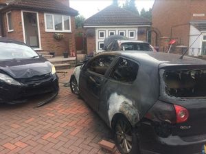 The aftermath of the blaze showing damage to three cars