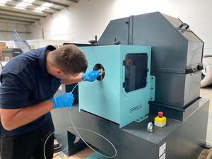 AWI wire technician Daniel Holyhead operating their new specialist linishing machine