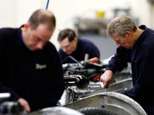 Engineers working in a factory (David Davies/PA)