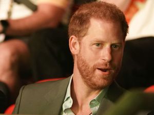 Supporting image for story: Harry pictured meeting US firefighters and therapy dogs before legal settlement