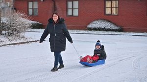 Jack Davenport, aged 6, and Nicky Davenport take the chance to play in the snow