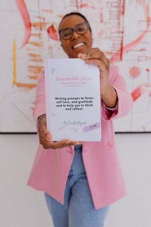 Danielle showcasing one of her journals that she created for pre-teen girls.