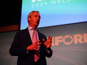 Nigel Farage on stage at the Reform UK Welsh Conference
