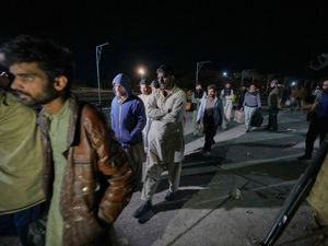 Passengers rescued by security forces from a passenger train attacked by insurgents arrive at a railway station in Much, Pakistan’s southwestern Balochistan province